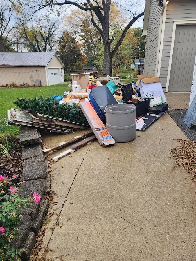 Dumpster being loaded with debris for Estate Cleanout Dumpster Rental in Williston